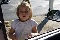 Innocent beautiful girl begging on the street.